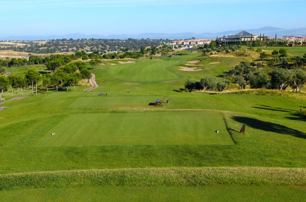 Elevated tee at Golf Santander near Madrid looking down the fairway with the Sierra de Guadarrama on the horizon